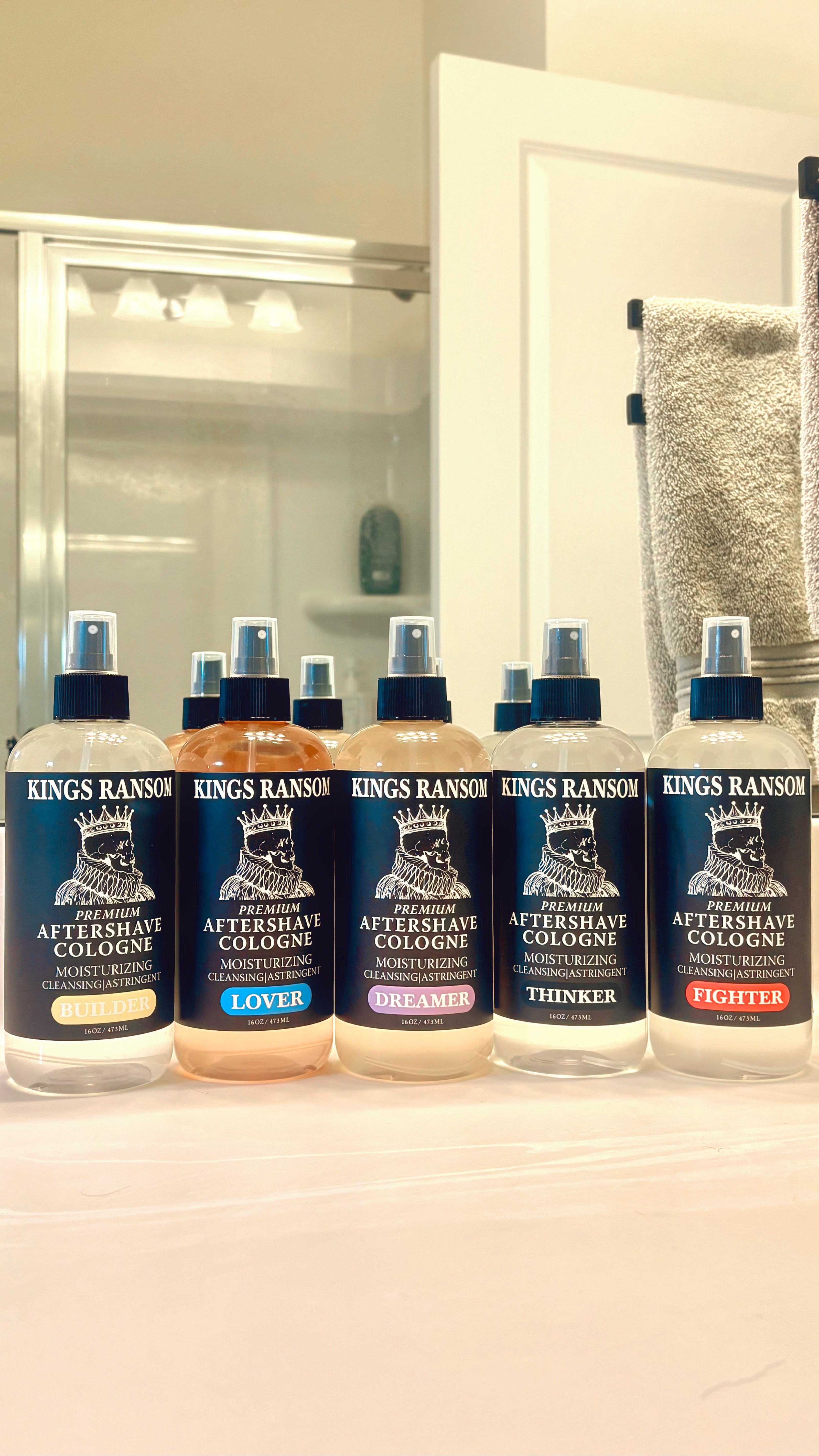 Five bottles of Kings Ransom aftershave cologne on a bathroom counter.